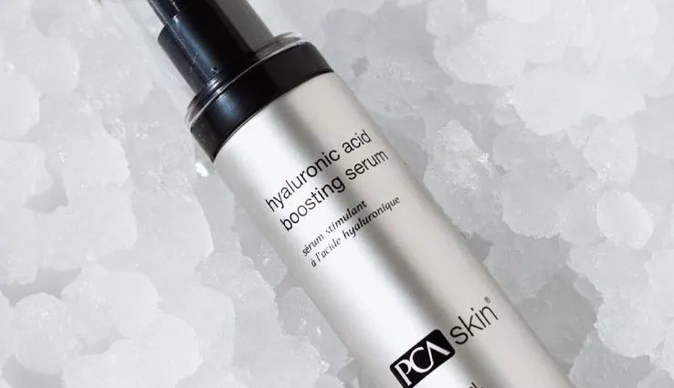 PCA SKIN Hyaluronic Acid Boosting Serum bottle sitting in ice.